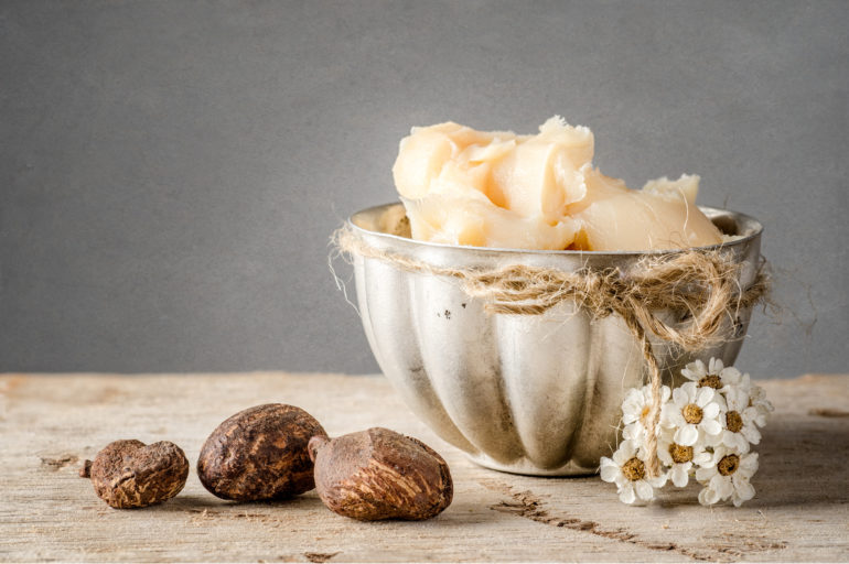 Cup of shea butter with shea nuts